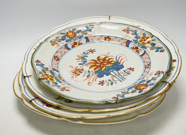 Three porcelain plates comprising an 18th century Meissen floral example and two Sevres, together with an 18th century polychrome tin glazed, largest 25cm in diameter. Condition - fair